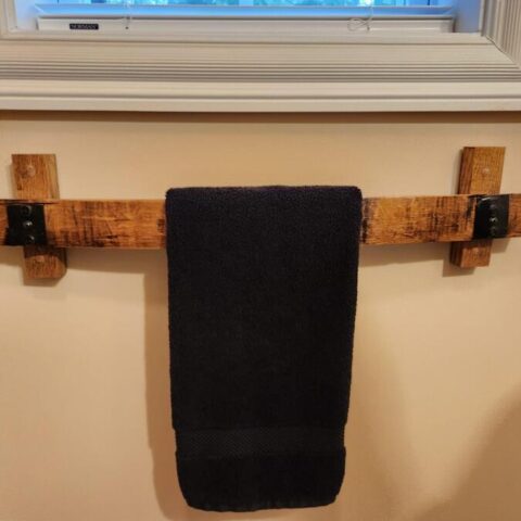 Barrel stave towel rack mounted to a wall