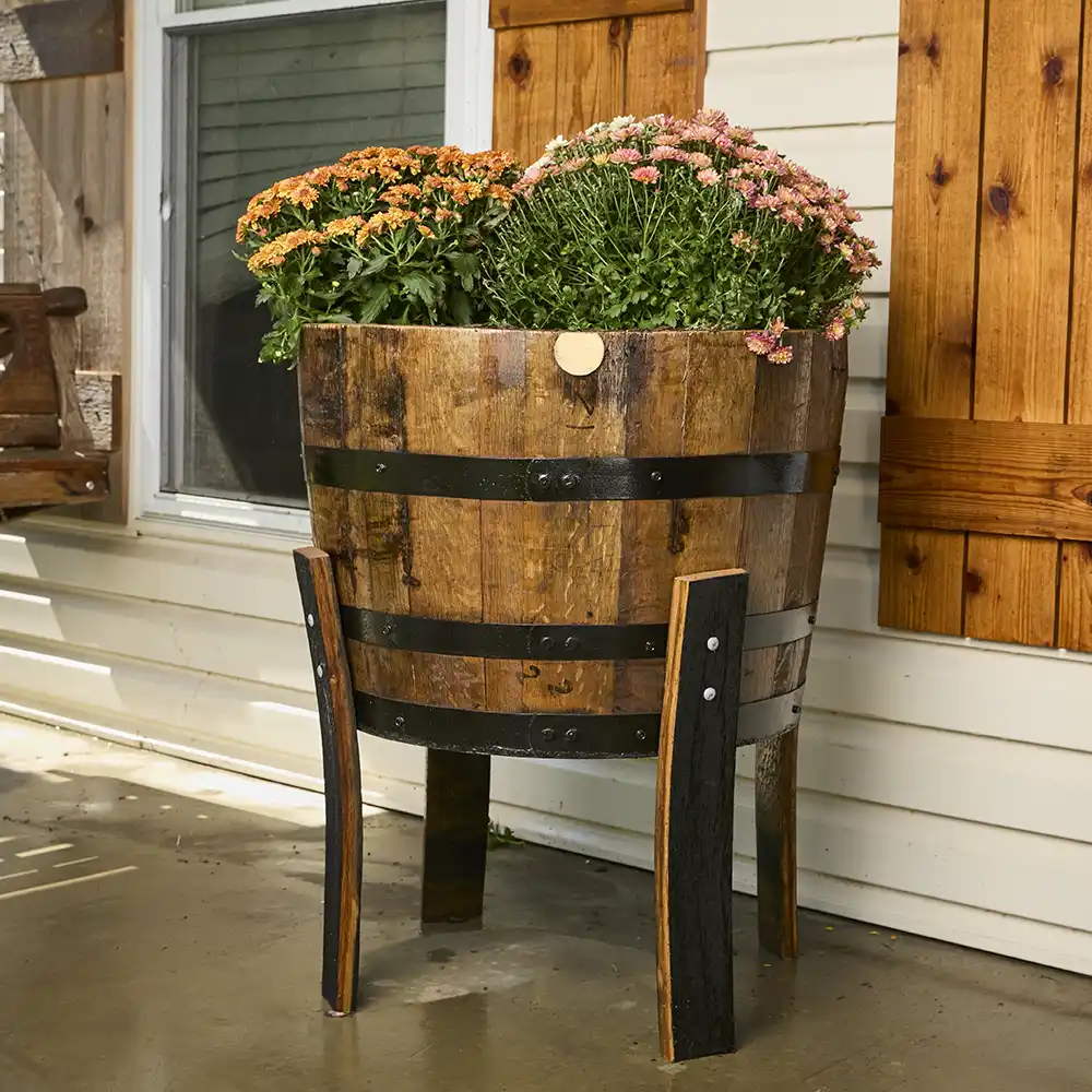 Bourbon barrel planters staged outside the shop