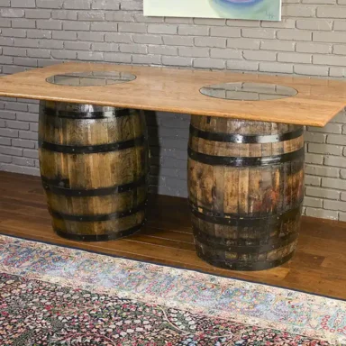 2 whiskey barrel table with a solid oak top and 2 glass inserts to show the distillery stamps on the barrels.