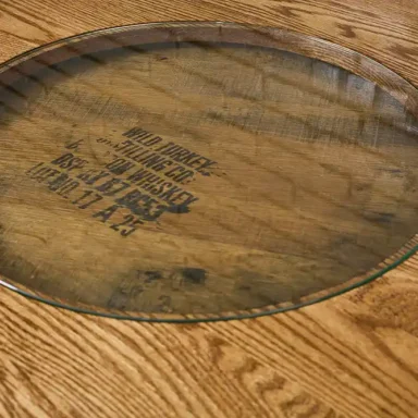 solid oak tabletop on a barrel table with the glass insert to show off the distillery stamp on the barrel
