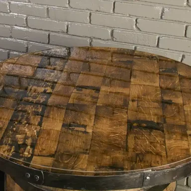 table top made from barrel staves and epoxy resin. Metal rings from the barrel secured to the edge and painted black.