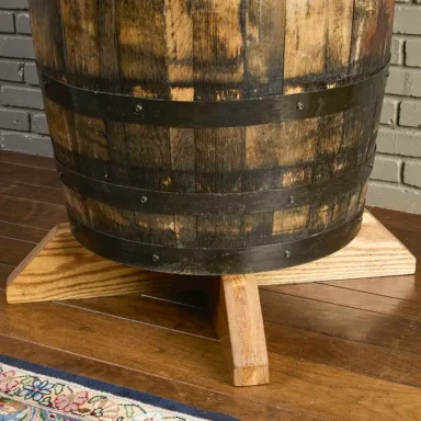 Oak base under a whiskey barrel table that raises the barrel table to pub height