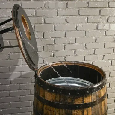 Deluxe barrel trash can cover with lid open and supported by chains. Metal liner inside the barrel