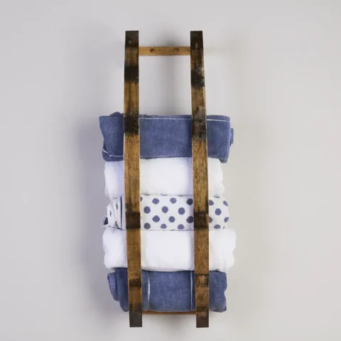Barrel stave towel rack holding multiple rolled bath towels
