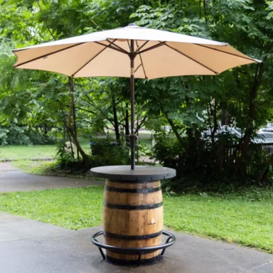 outdoor barrel table with footrest and umbrella
