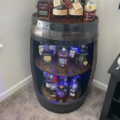 Whiskey barrel cabinet with assorted bottles